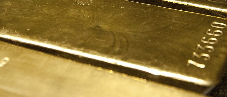 Gold bars seen close up, their faces catching the light
